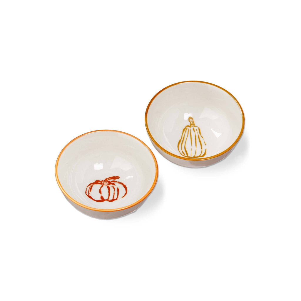Two ceramic bowls, one with pumpkin design in orange and other with gourd design in goldenrod, on a white background.