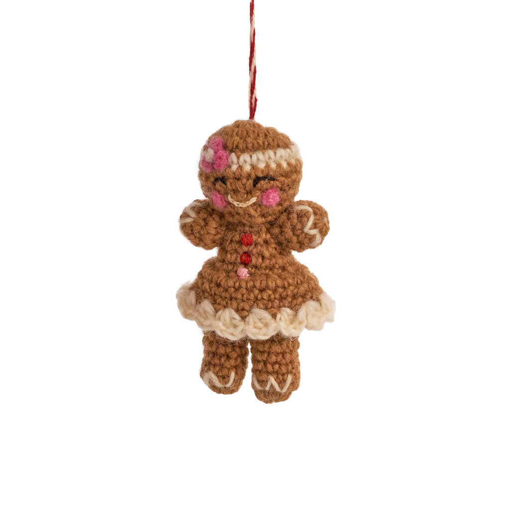 Crocheted gingerbread girl ornament on a white background.