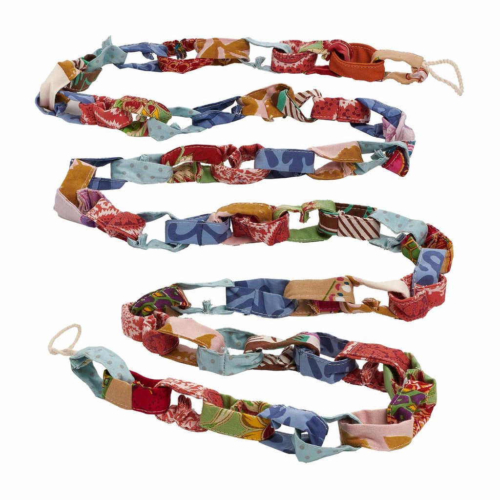 Colorful patchwork fabric chain garland with loops at end, on a white background.