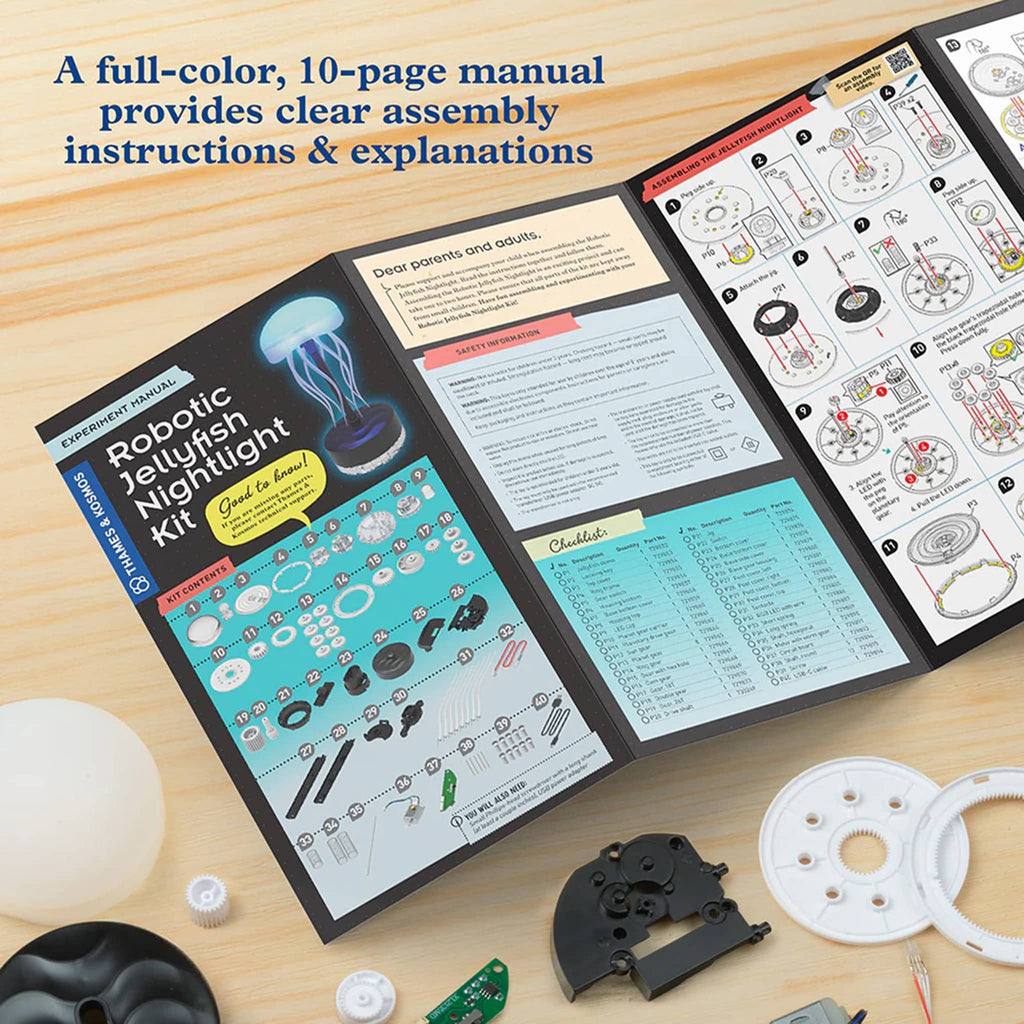 Open manual for a robotic jellyfish nightlight kit on a wooden surface with components.