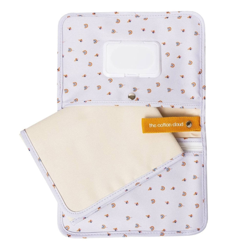 The Cotton Cloud Diaper Clutch Bag and Changing Pad with rainbow and ice cream print on white backdrop, open showing interior features.