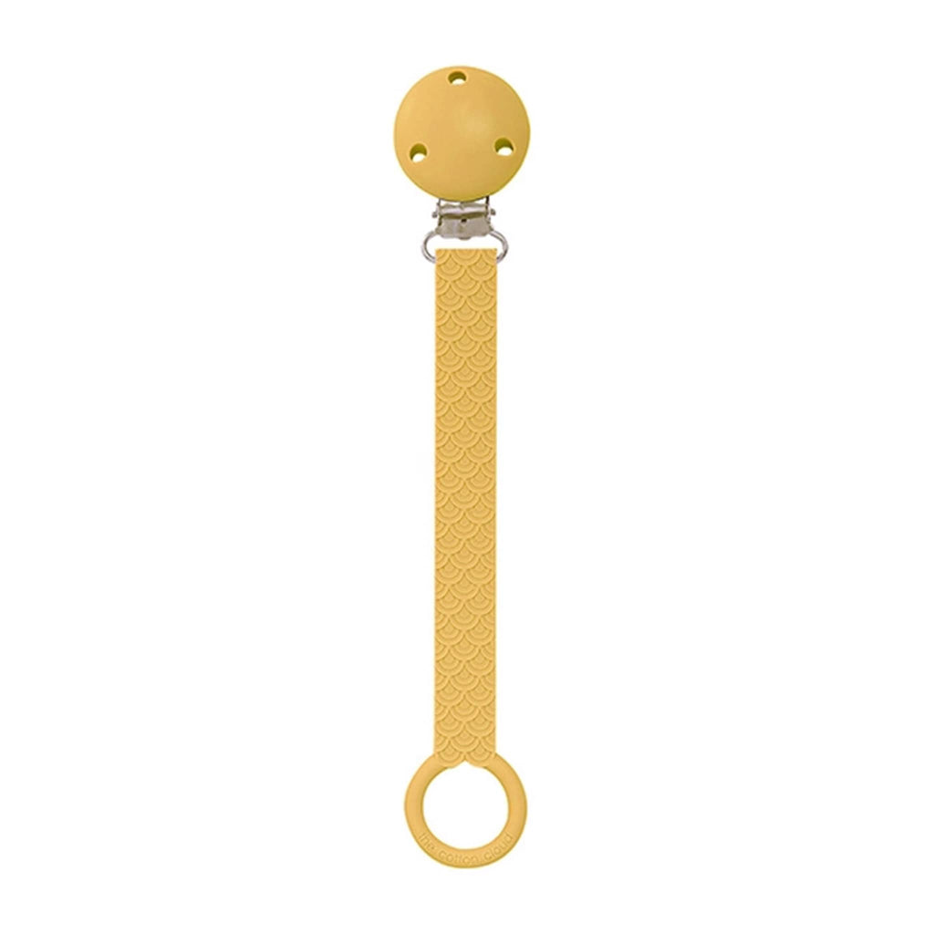 The Cotton Cloud Scallop silicone pacifier holder in golden toffee.