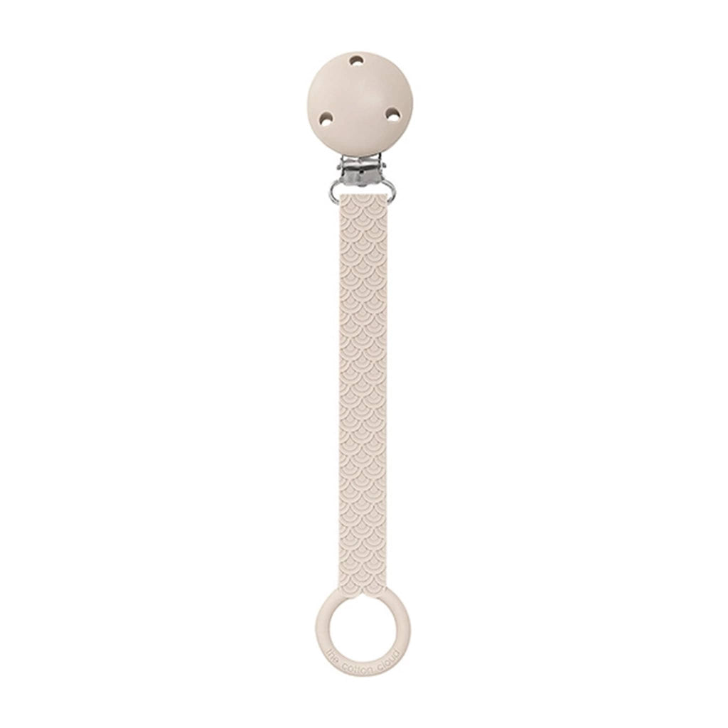 The Cotton Cloud Scallop silicone pacifier holder in sand beige.