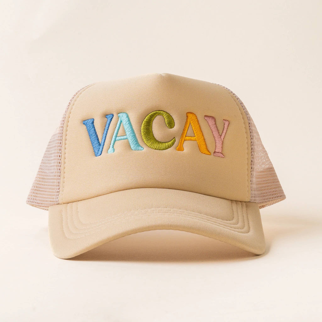 The Darling Effect beige trucker hat with "Vacay" in colorful lettering on the front.