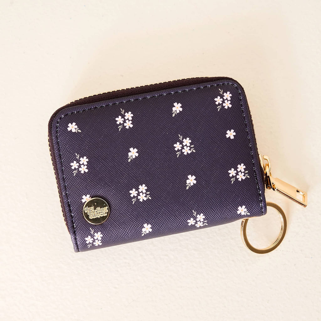 The Darling Effect Zip Around Wallet in Pretty Posies print on navy blue backdrop, front view.