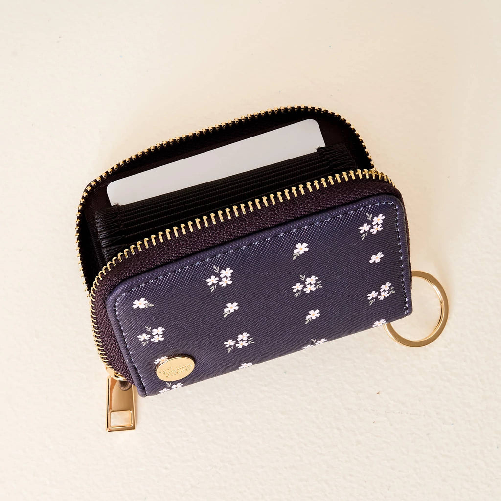 The Darling Effect Zip Around Wallet in Pretty Posies print on navy blue backdrop, unzipped showing inside.