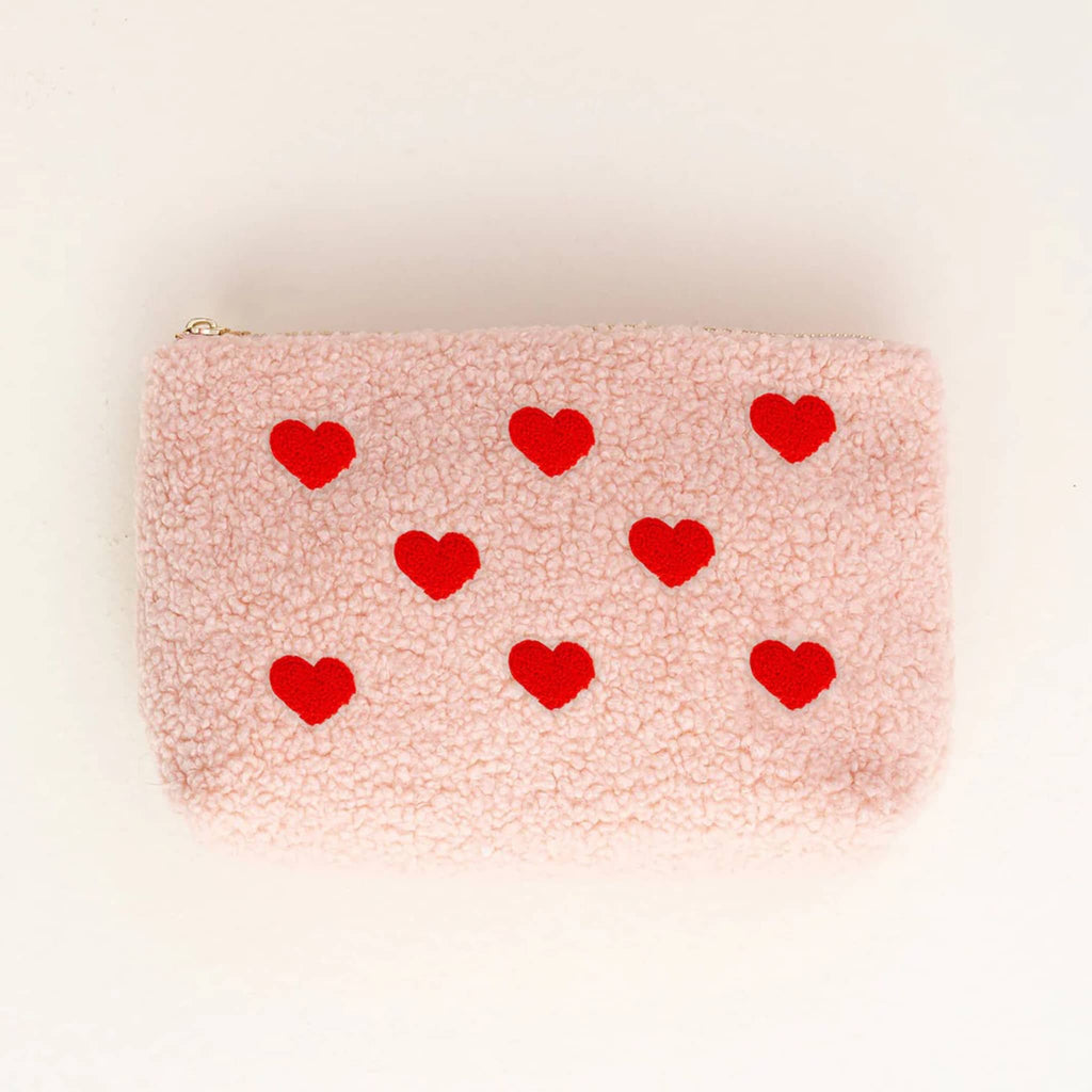 The Darling Effect teddy sherpa zip pouch in pink with red hearts, front view.