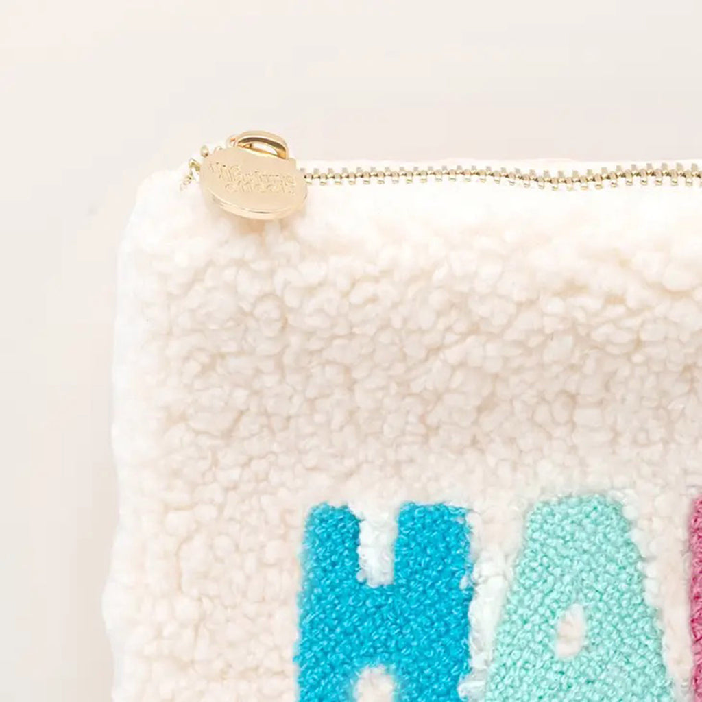 The Darling Effect Cream Teddy Zip Pouch with Happy in shades of blue, pink and yellow lettering, front view, detail of zipper pull.