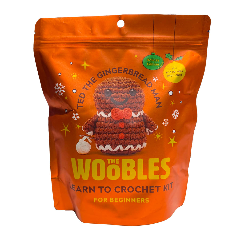 Orange packaging of 'The Woobles' learn to crochet kit with a gingerbread man design.