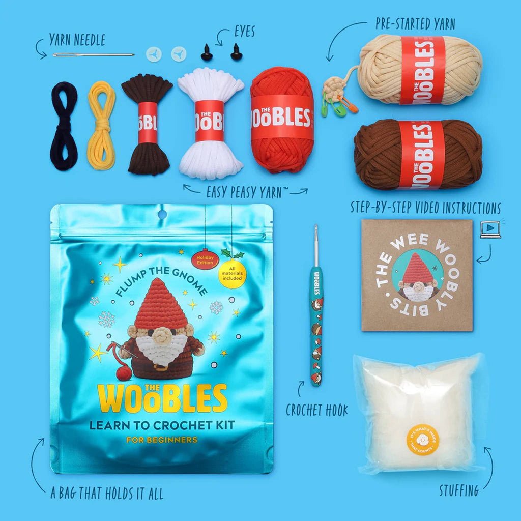 Packaging and contents of The Woobles Flump the Gnome beginner crochet kit on a blue background.