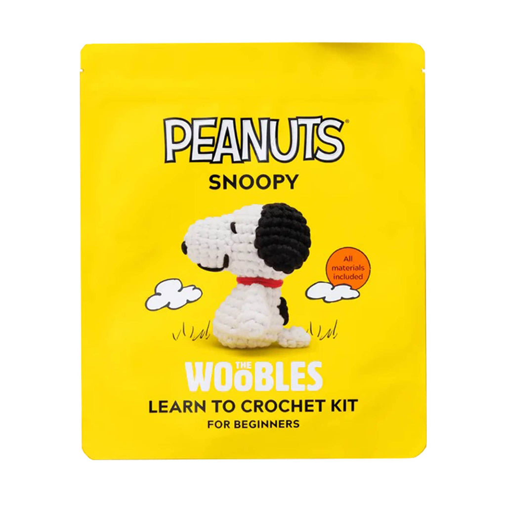 Yellow packaging of The Woobles Snoopy beginner crochet kit on a white background.