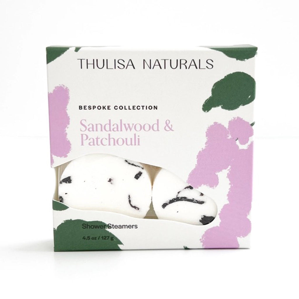 Thulisa Naturals Sandalwood & Patchouli all natural shower steamers in green and purple illustrated box packaging, front view. 