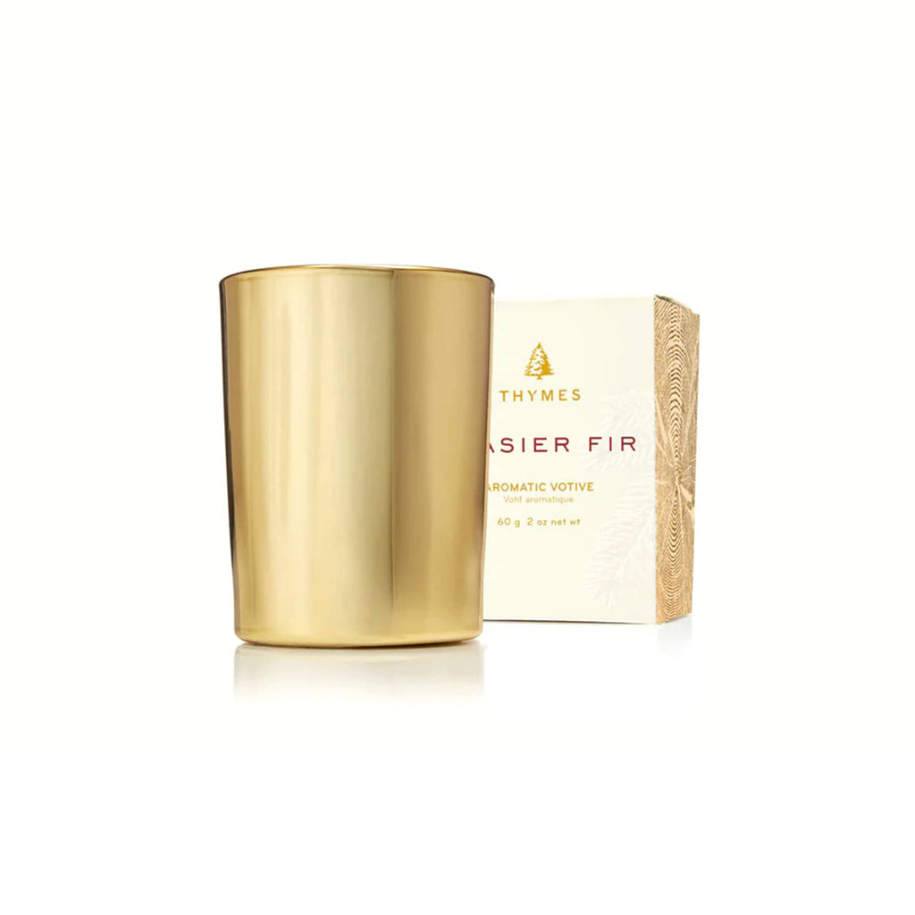 Gold votive candle and box packaging on a white background.