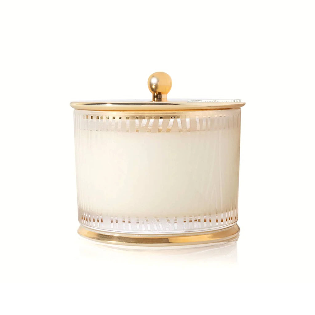 Decorative frosted glass jar with wood grain pattern and gold rim and lid on a white background.