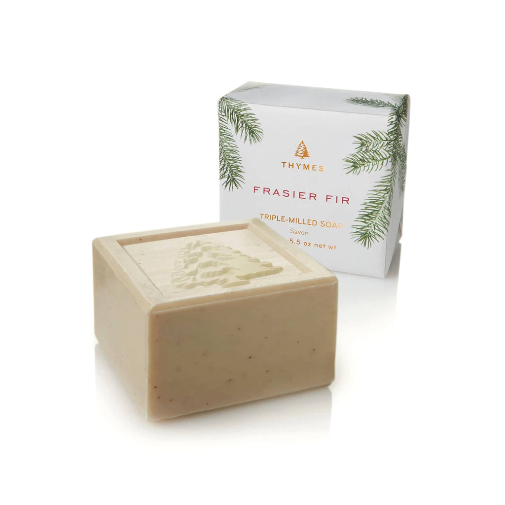 Thymes Frasier Fir Scented Bar Soap Trio, boxed soap wrapped in pine needle wrapping paper beside an unwrapped bar.