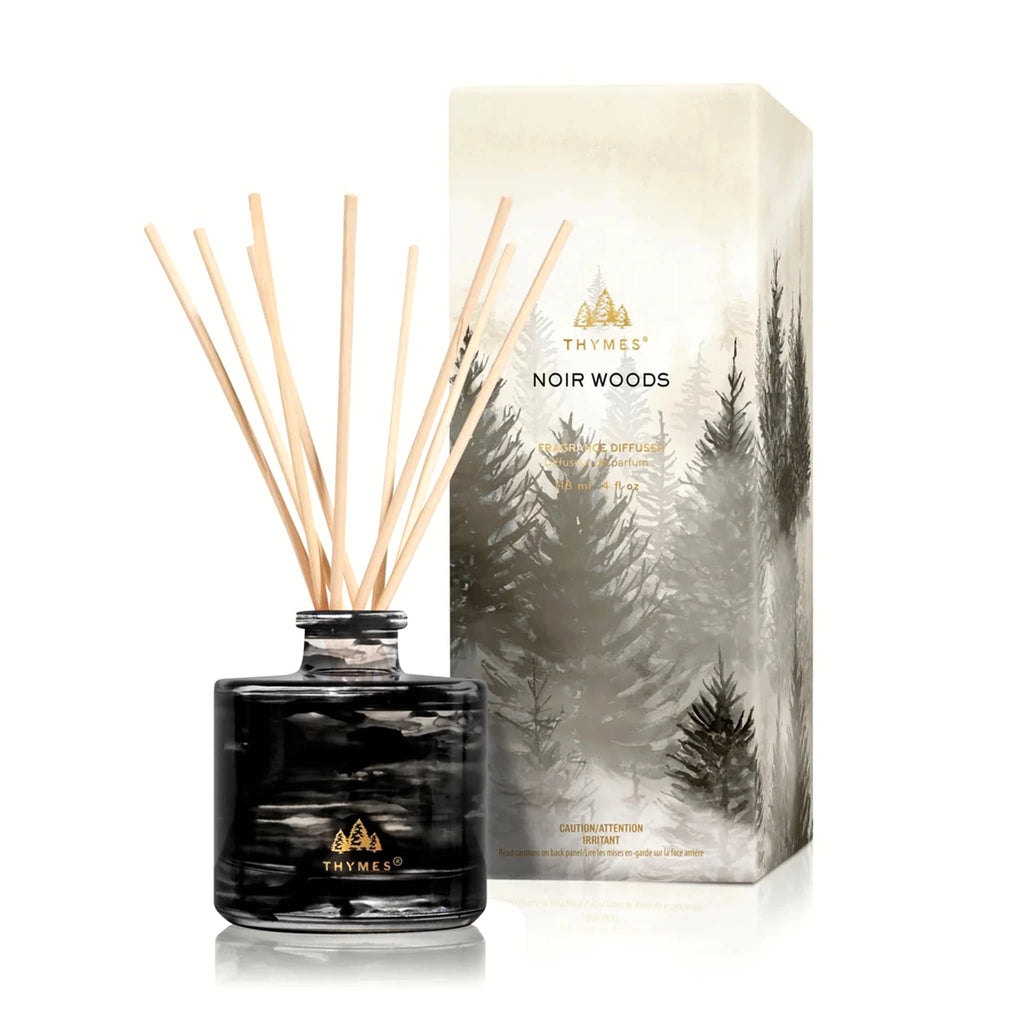 Thymes Noir Woods diffuser with packaging featuring forest design, on a white background.