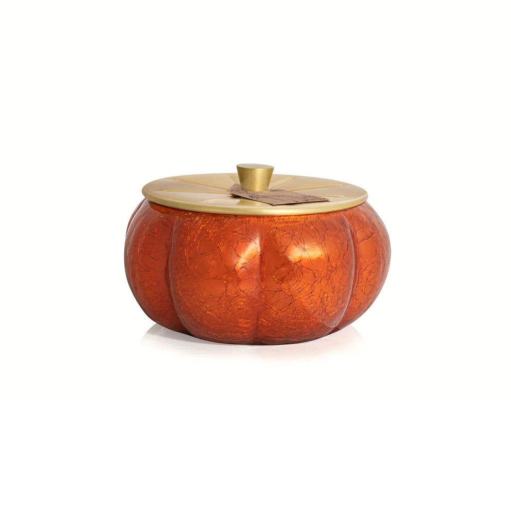 Pumpkin Laurel scented candle in decorative pumpkin-shaped container with a gold lid on a white background.