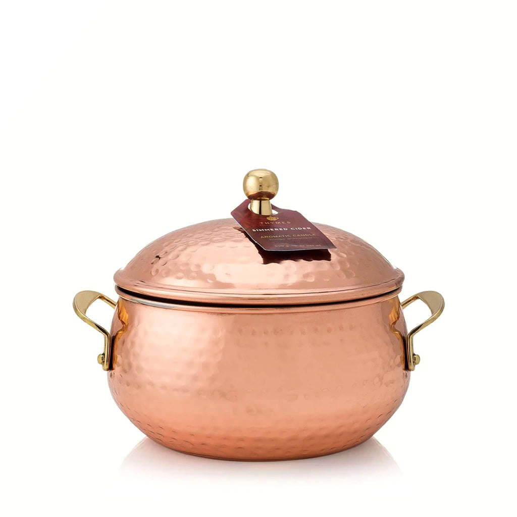 Simmered Cider scented candle in a copper pot with a lid on a white background.