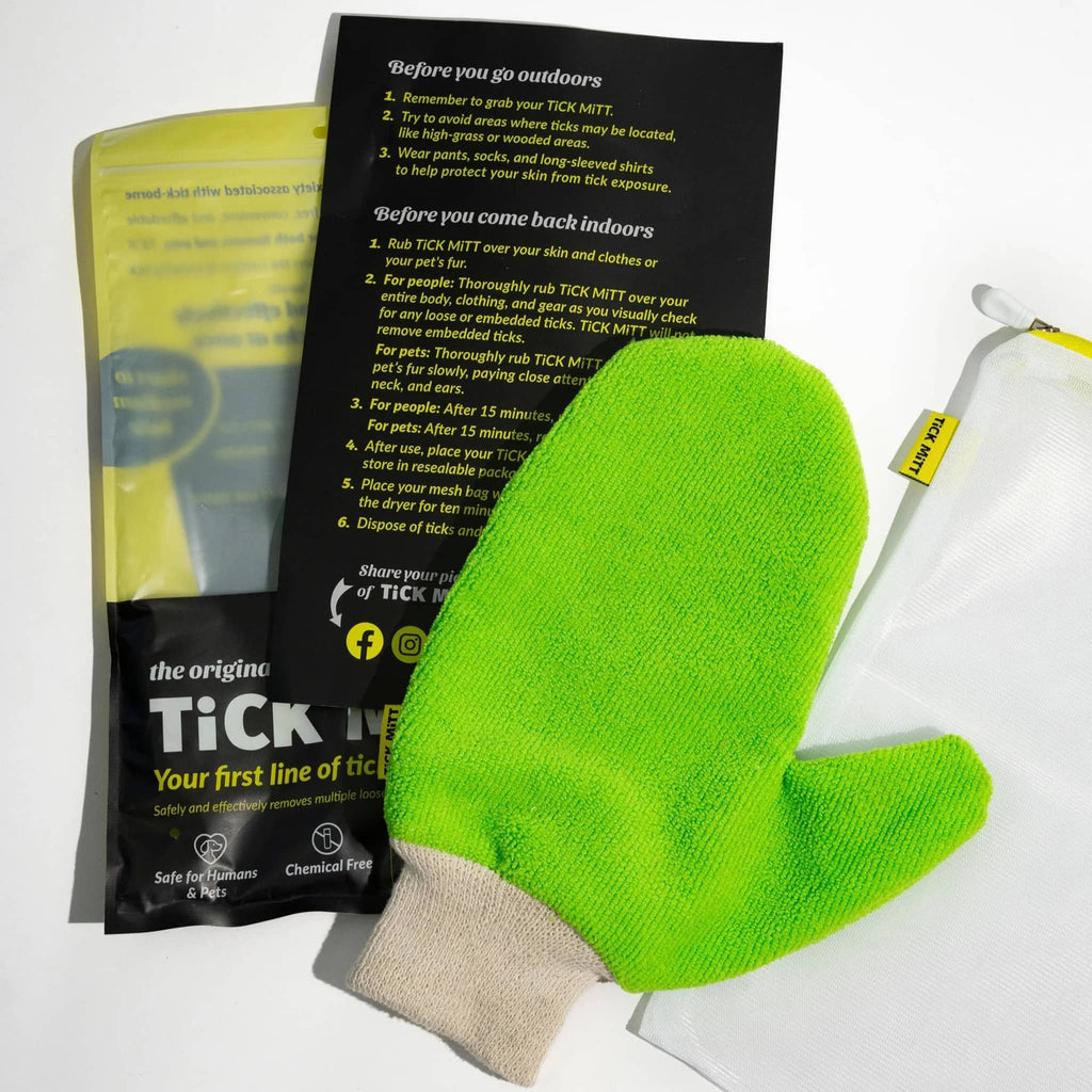 Tick Mitt in green, adult size, front view with packaging and contents.