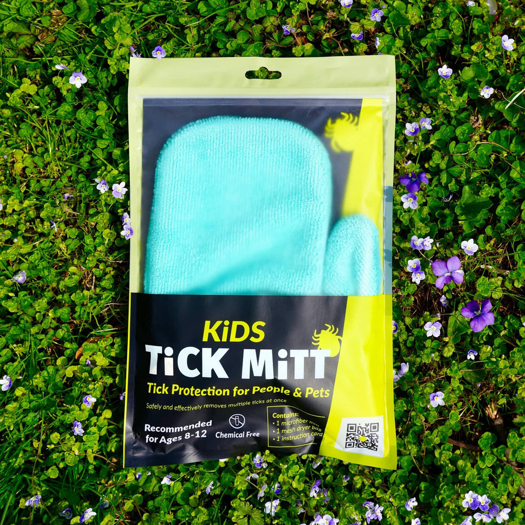Kids Tick Mitt in blue, in pouch packaging on grass.