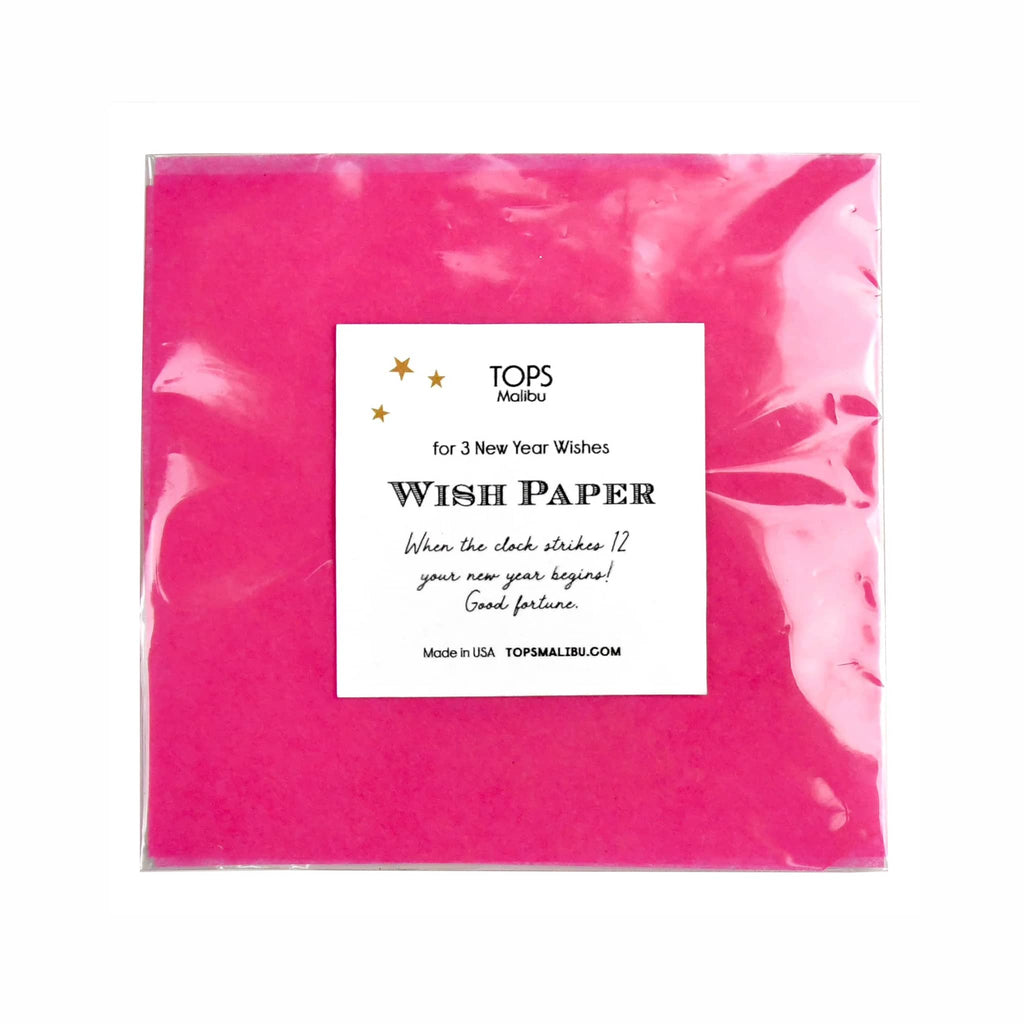 Pink wish paper with a label on a white background.