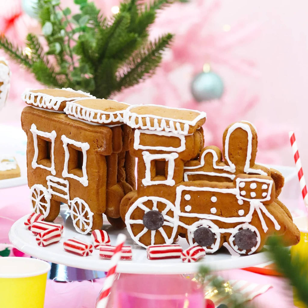 Gingerbread train decorated with icing on a festive background.