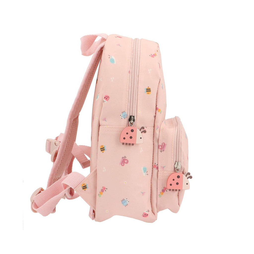 Pink backpack with small bug illustrations and ladybug charm zipper pulls, side view on a white background.