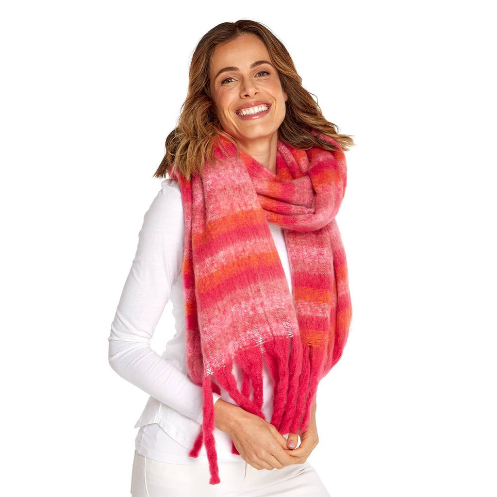 Two's Company red and pink striped winter scarf with fringe, shown on model.