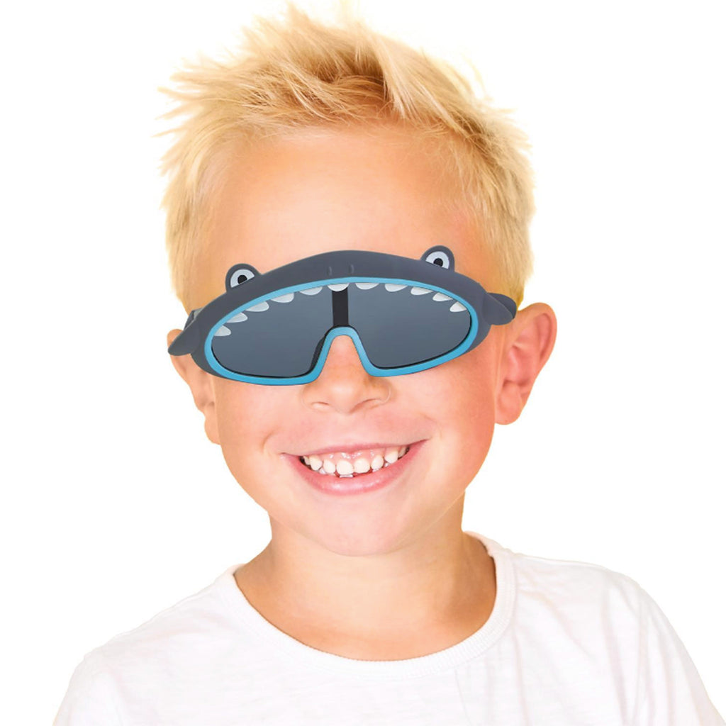 Cupcakes & Cartwheels Jaw-some kids shark sunglasses with gray frames, being worn by a child.