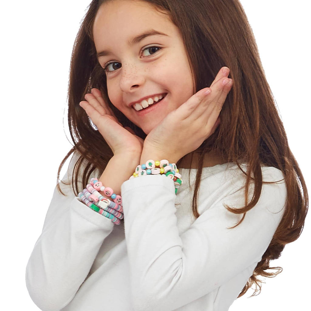 Two's Company kids christmas themed elastic bracelets with beads and charms on a girls wrists.