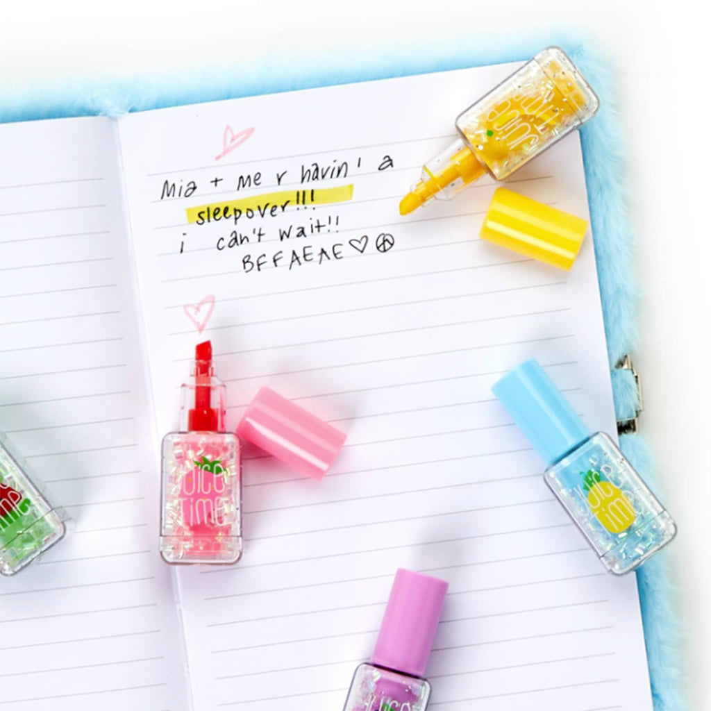 Two's Company Nail Polish Highlighter Pen in bottles that look like nail polish, shown with caps off on a journal.