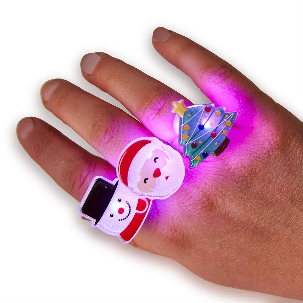 Two's Company Flashing Light Up Holiday plastic novelty adjustable ring in 3 styles: snowman, santa and christmas tree on a hand and lit up.