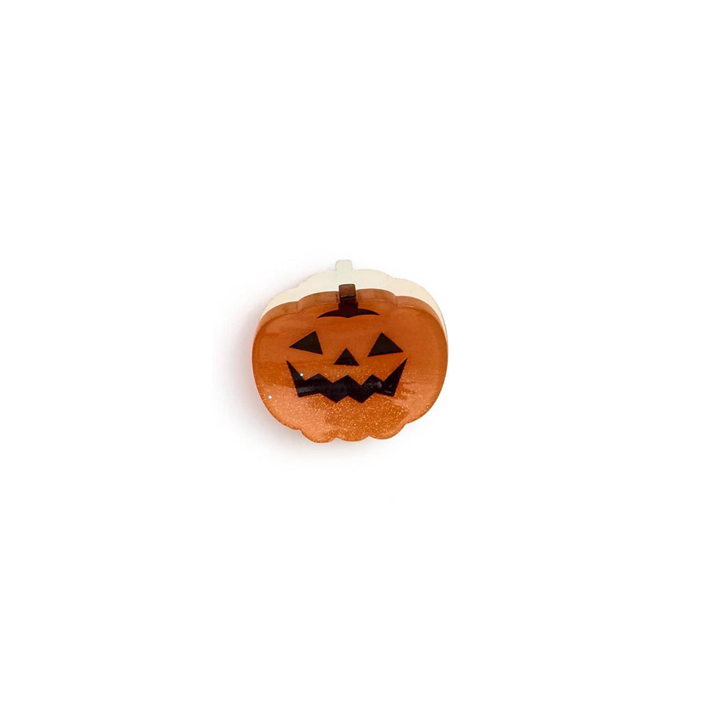 Small plastic pumpkin hair claw clip on a white background.