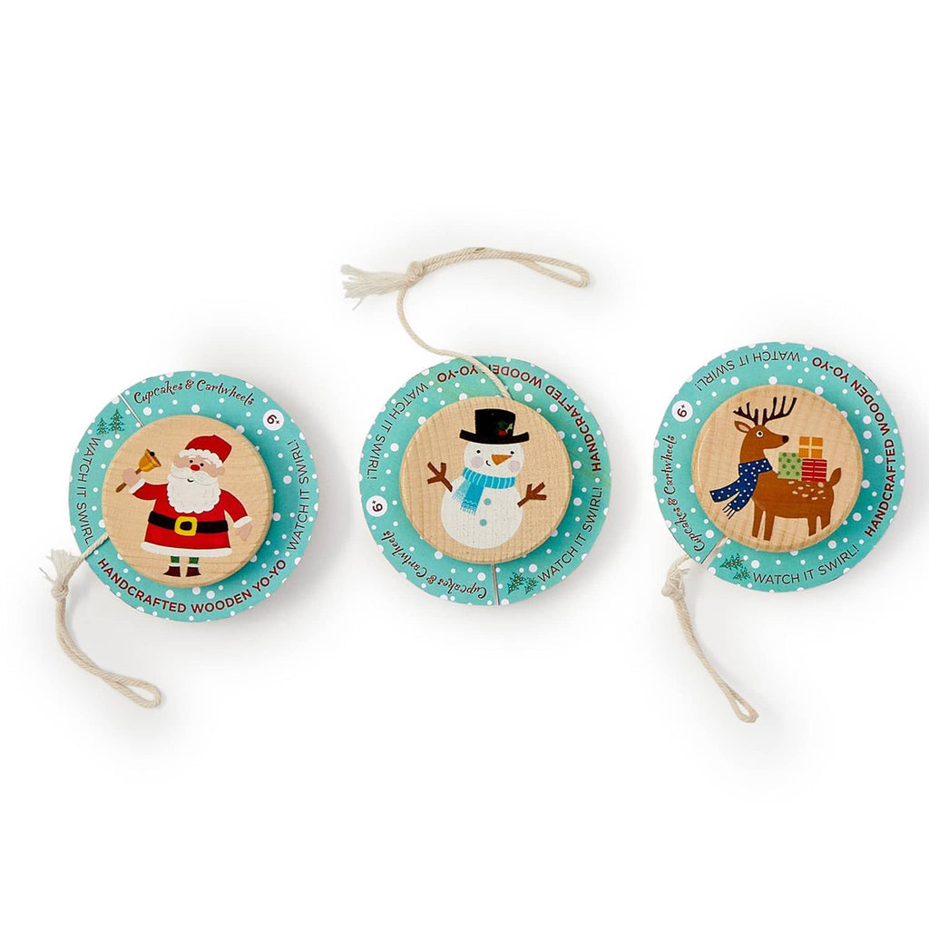Three wooden Christmas yo-yos with Santa, snowman, and reindeer designs on a white background.