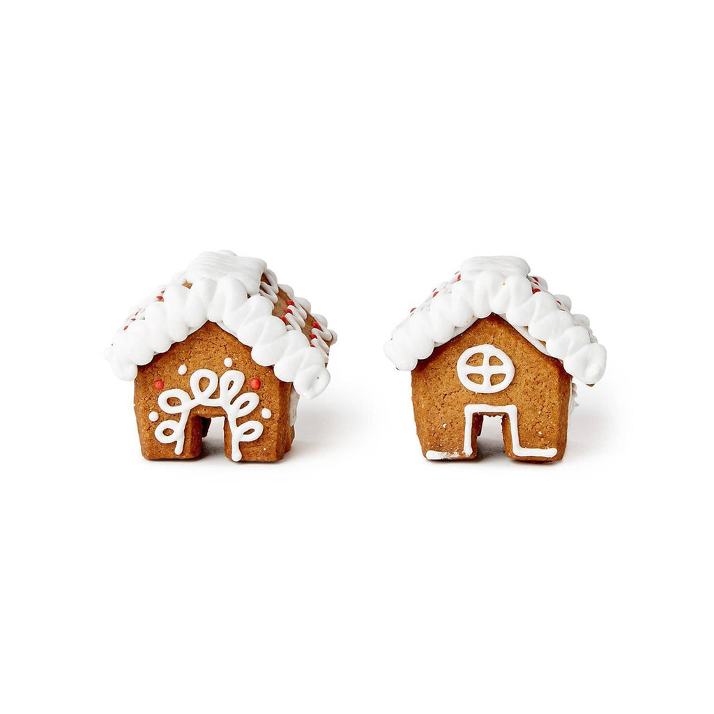 Two small gingerbread houses with white icing on a white background.