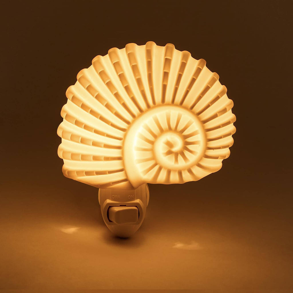 Two's Company Nautilus Shell Decorative Night Light, front view, lit in dark room.