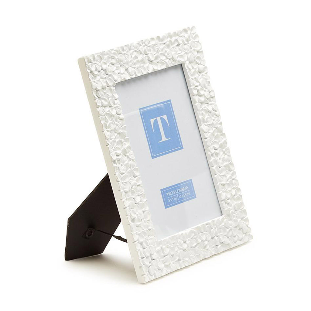 Two's Company 5x7 inch picture frame with white resin hydrangea pattern, side view.