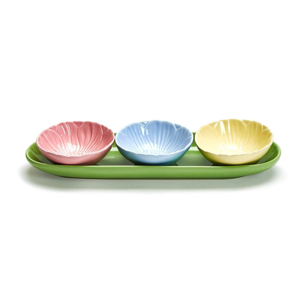 Two's Company pink, blue and yellow ceramic bowls that look like flowers on a green ceramic tray.