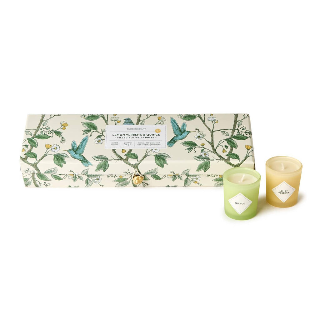 Two's Company Lemon Verbena & Quince scented votive candles in botanical print box, one in green and one in yellow shown outside of box.