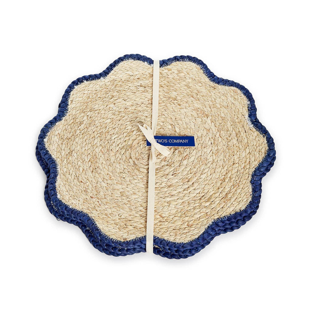 Two's Company Handwoven Seagrass Placemats with navy scalloped edge, set of four in packaging.