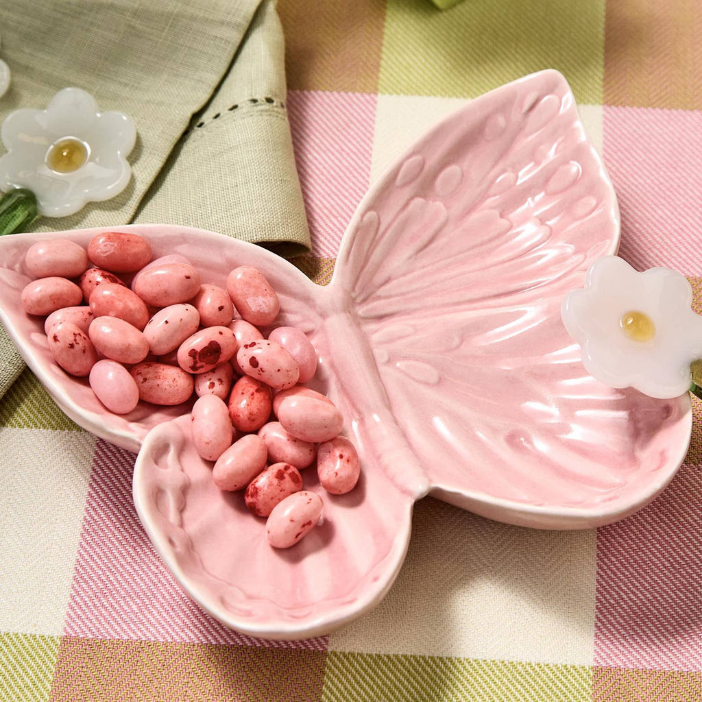 Two's Company Butterfly-shaped porcelain tidbit dish in pink with pink jellybeans.