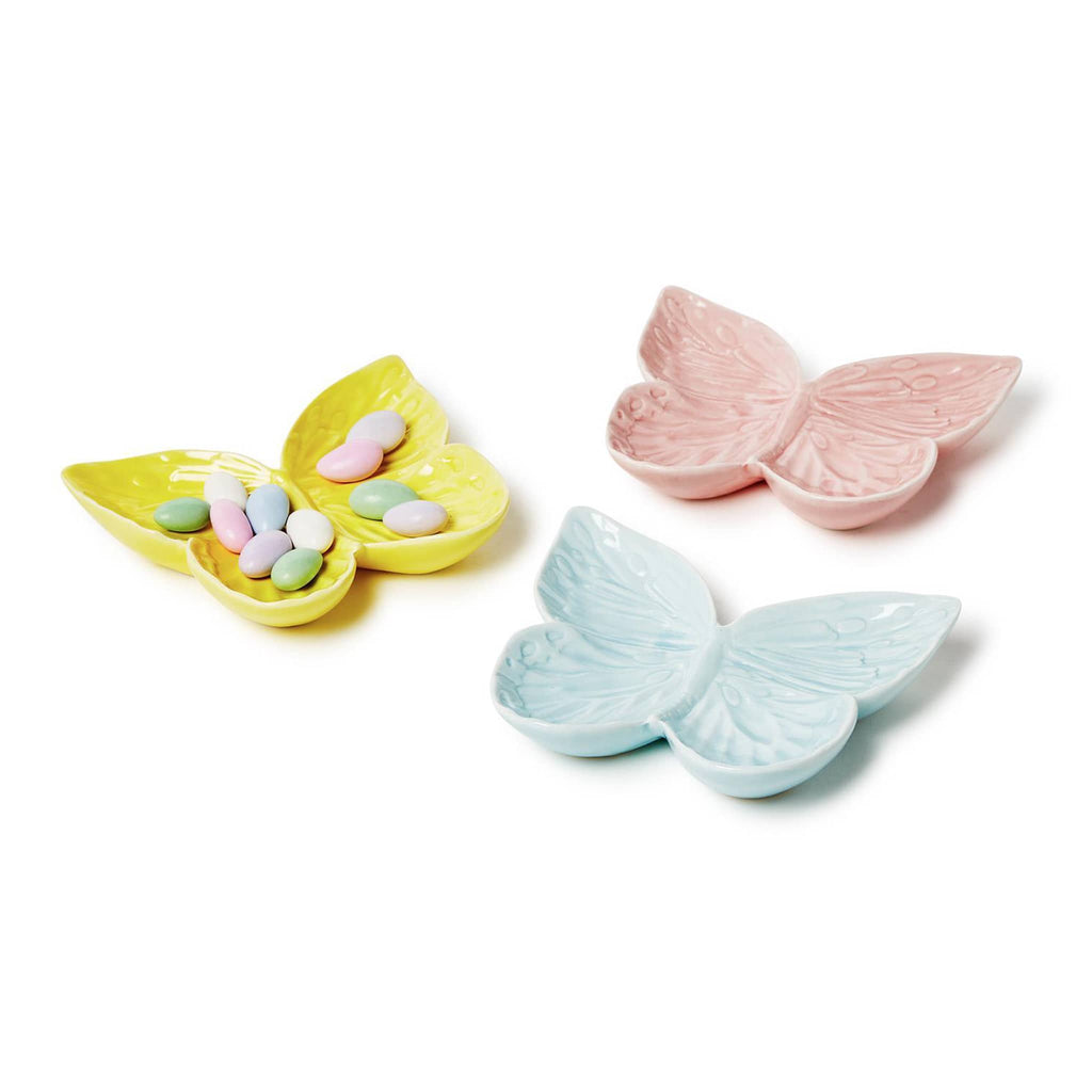 Two's Company Butterfly-shaped porcelain tidbit dish in yellow, pink and blue, the yellow dish has candy coated almonds.