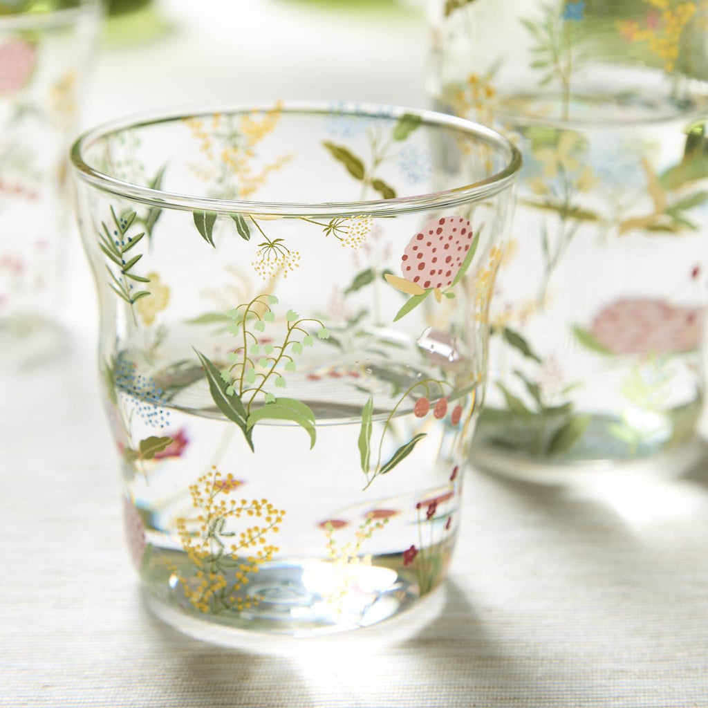 Two's Company Garden Delight Double Old Fashion Drinking Glass with floral print, filled with water.