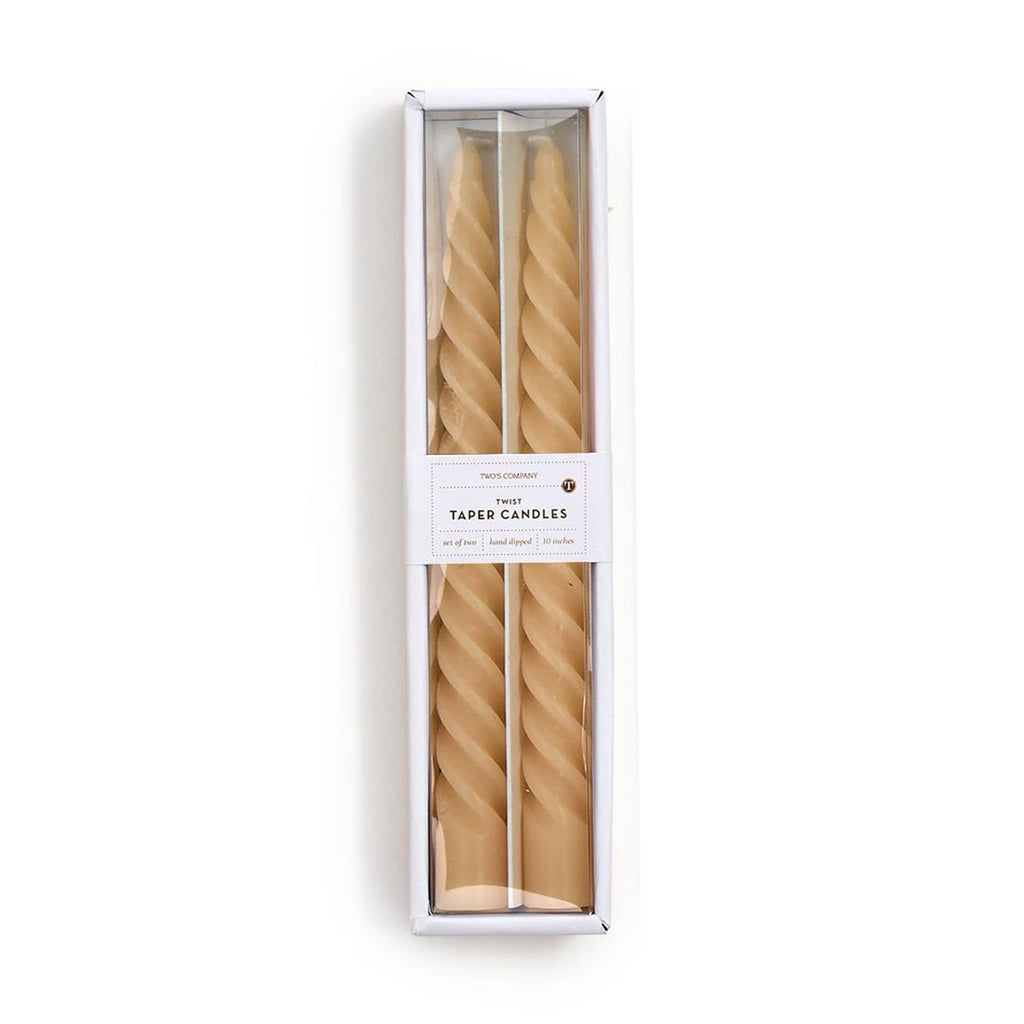 Two twisted ivory taper candles in a white box on a white background.