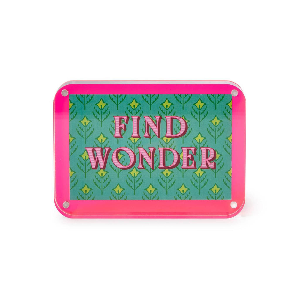 Pink acrylic frame with insert that says 'Find Wonder' on a green background, on a white background.