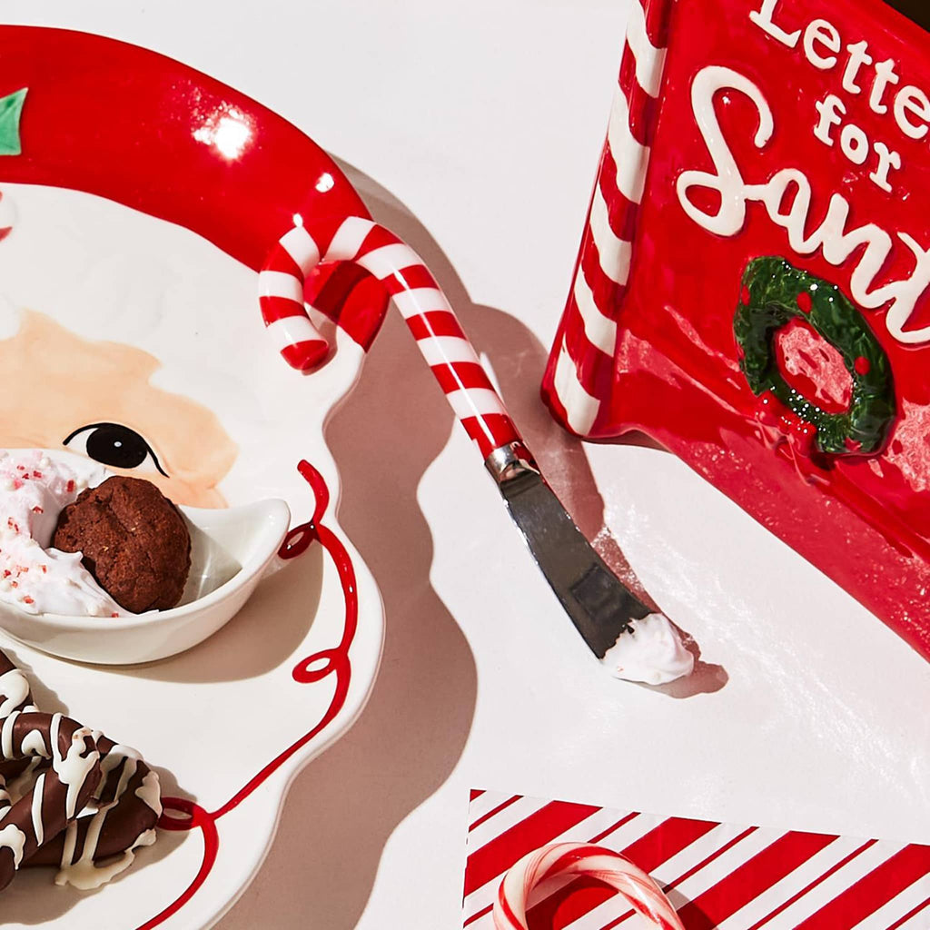 two's company peppermint twist cheese and jam spreader in stainless steel with red and white striped candy cane handle, shown with frosting.