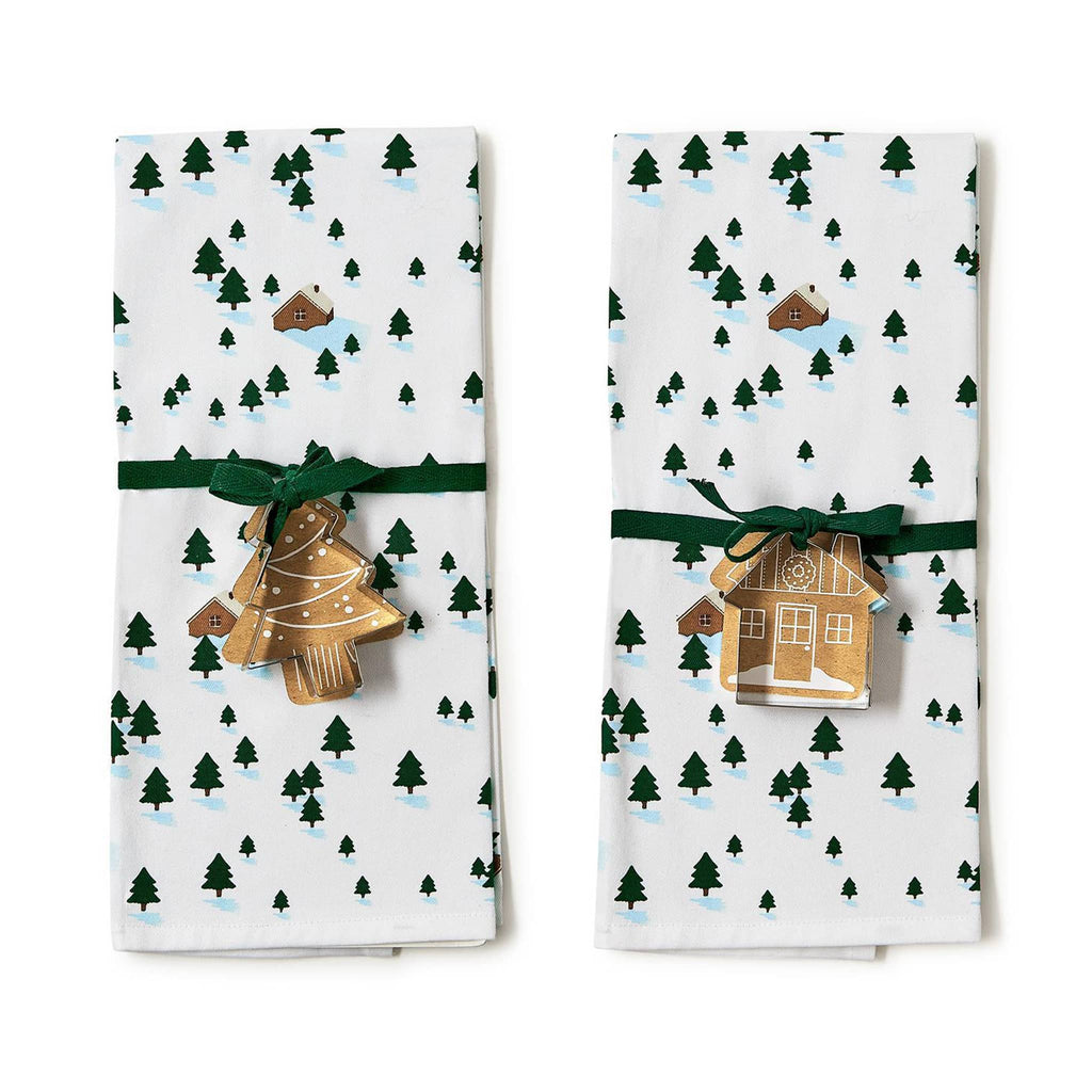 Two's Company winter scene dish towels with a tree or house shaped cookie cutter attached with a green ribbon.