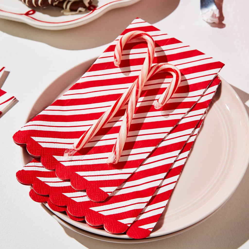 Two's Company Peppermint Twist Paper Guest Towels/Dinner Napkins, red and white striped napkins on dinner plate with candy canes on top.