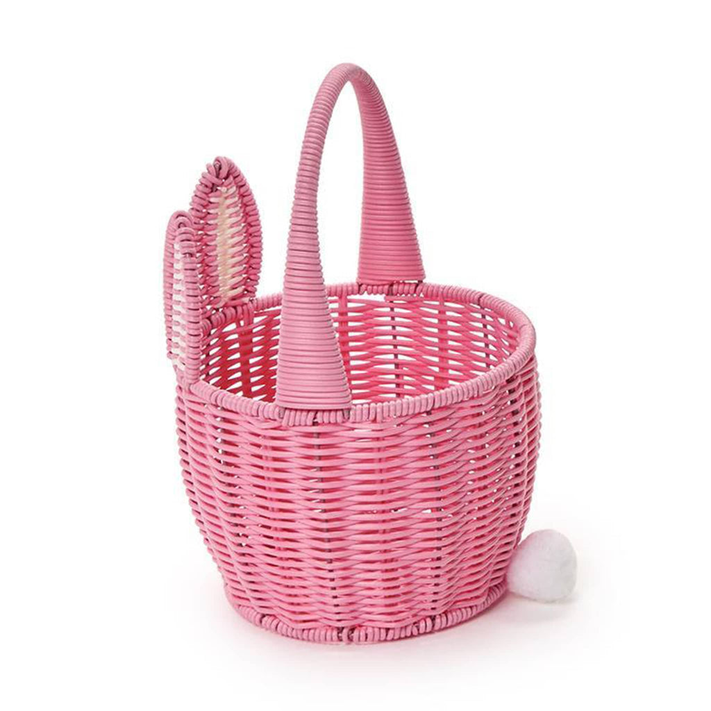 Two's Company Pink Faux Wicker Easter Basket with bunny ears, handle and pom pom tail, side view.