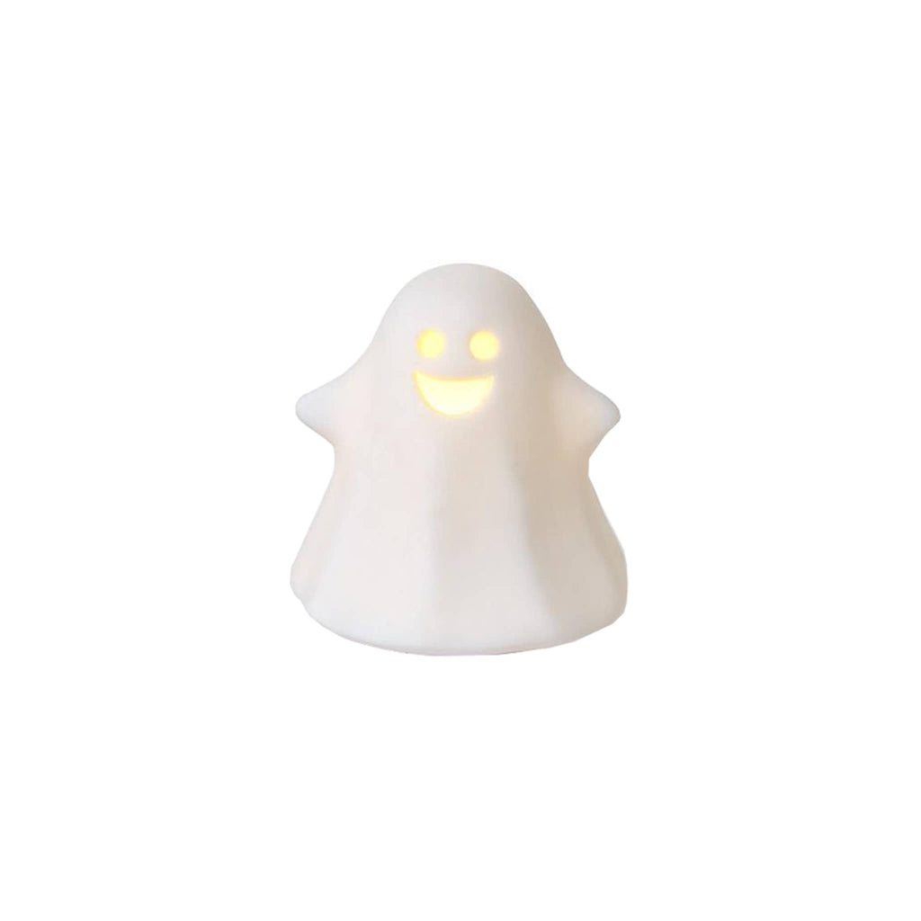 White ceramic ghost figurine with a smiling, glowing face on a white background.